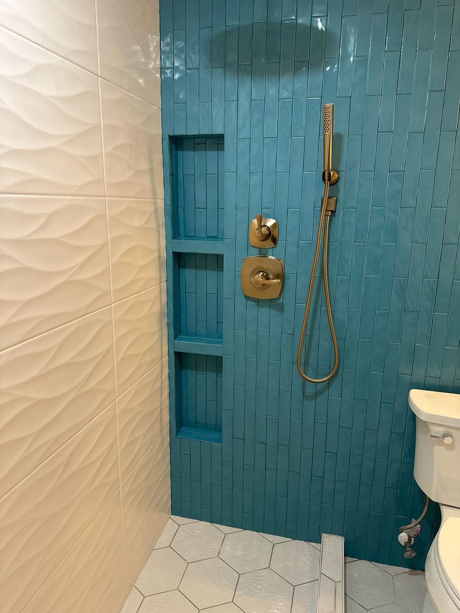 Custom shower remodel with 3-D tile, custom niches, brass trim and Schluter System, St. Augustine Beach FL